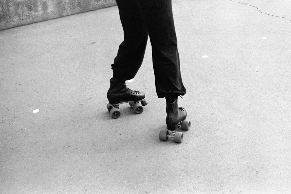 person in black pants and black shoes standing on gray concrete floor