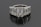 A luxurious ring featuring five large, rectangular emerald-cut diamonds set in a row. The diamonds are mounted in a shiny metal band, likely platinum, and reflect a brilliant shine against a dark background.