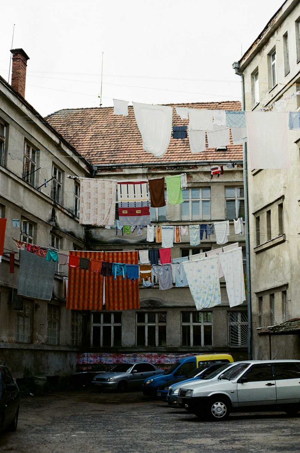 white and blue plastic bags hanged on brown wooden fence