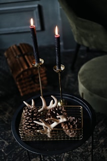 lighted candles on black metal candle holder