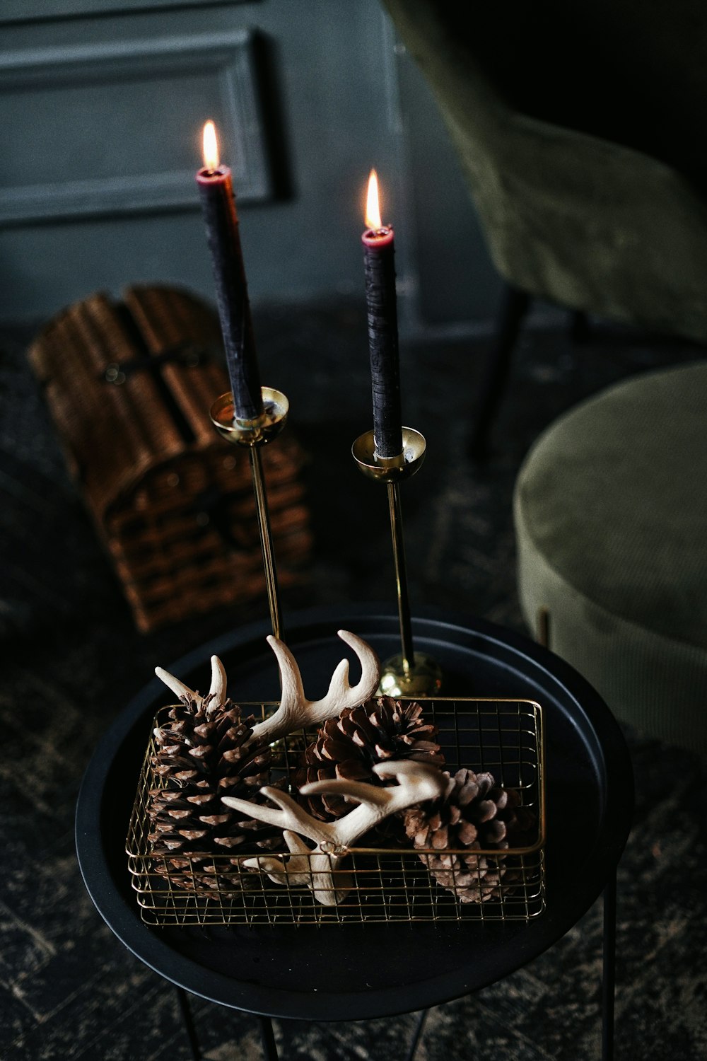 lighted candles on black metal candle holder