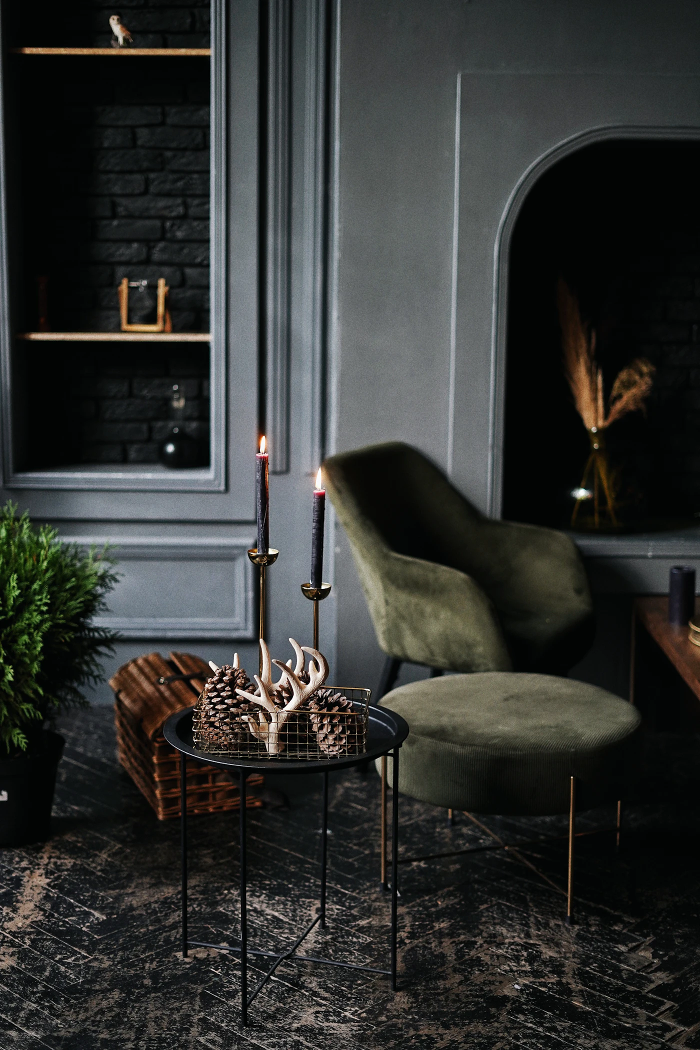 Olive velvet armchair with candles against a deep green wall (placeholder photograph)
