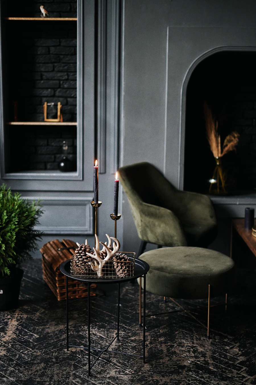 Olive velvet armchair with candles against a deep green wall (placeholder photograph)