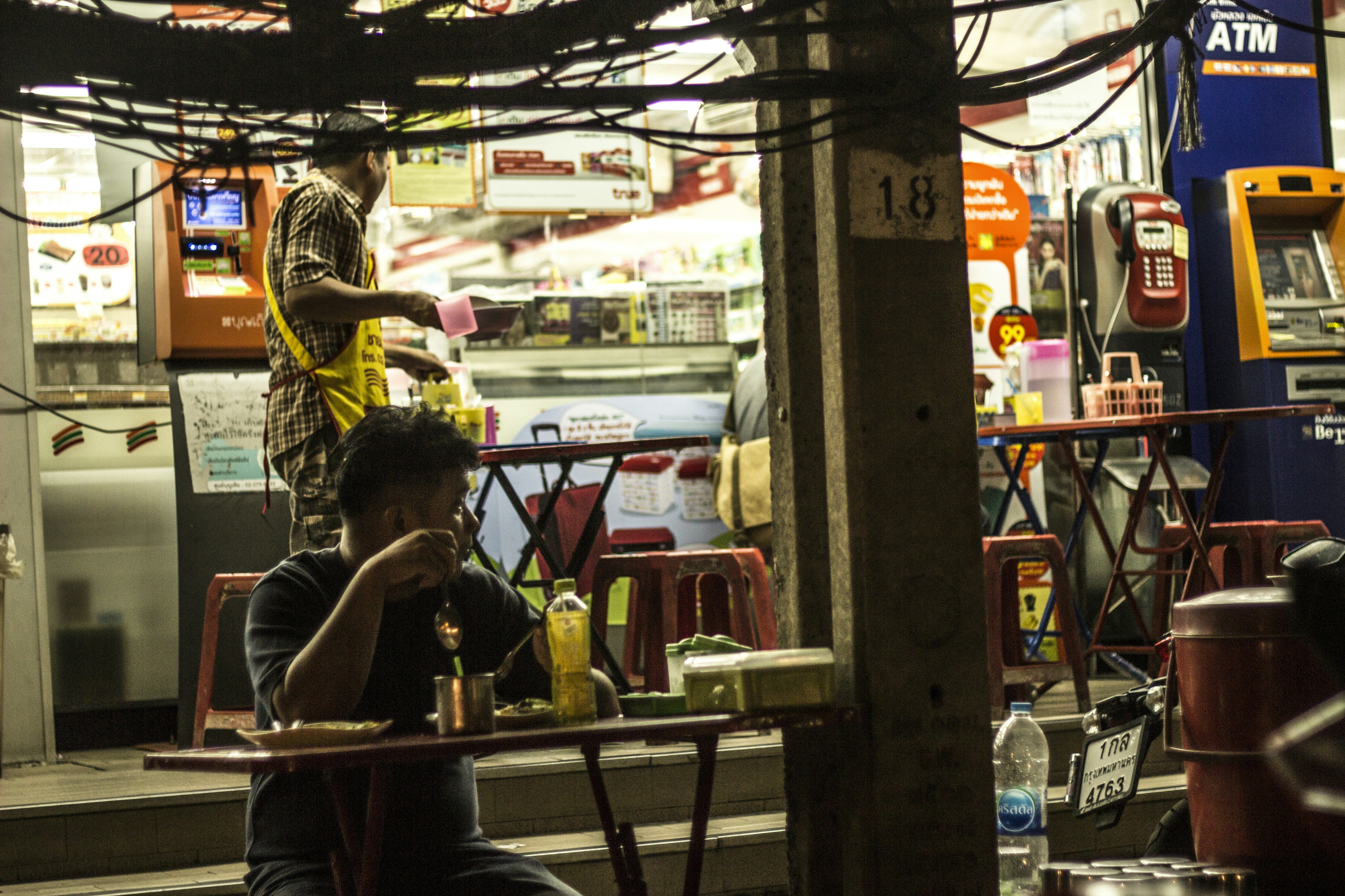 man in black t-shirt sitting on chair