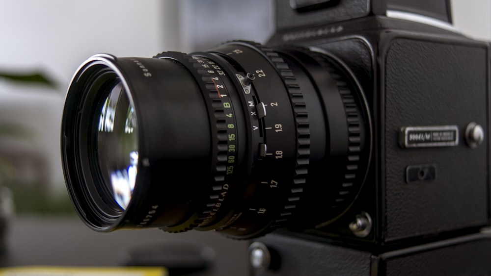 black camera lens on brown wooden table