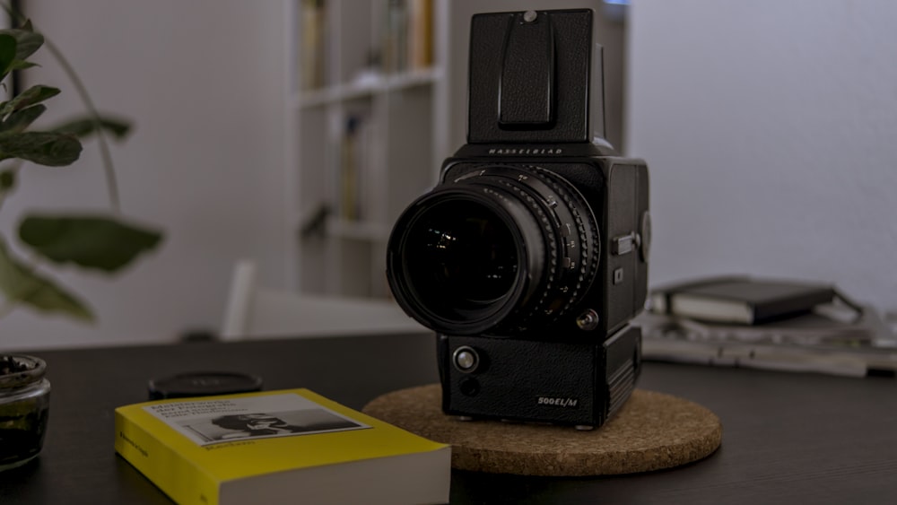 black nikon dslr camera on brown wooden table