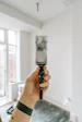 person holding white paint brush