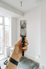 person holding white paint brush