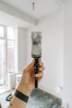person holding white paint brush