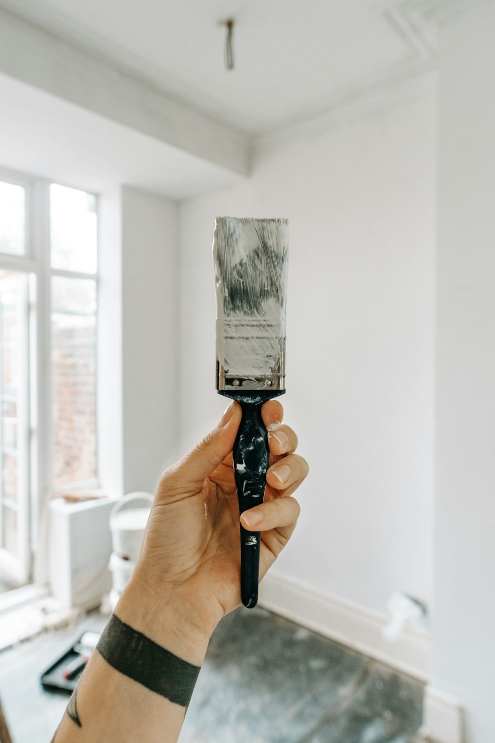 person holding white paint brush