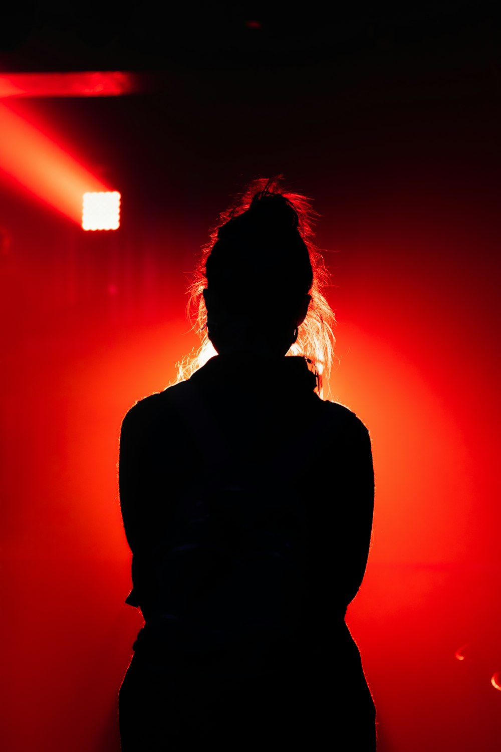 silhouette of person with red light