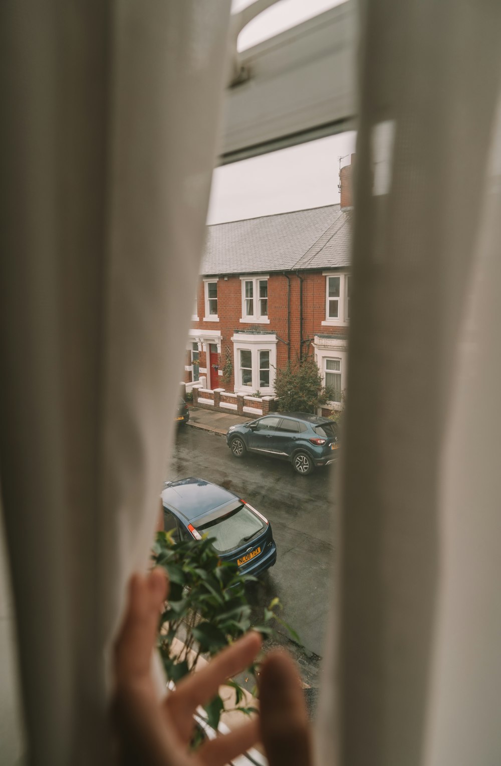 black car parked beside brown building during daytime