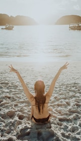 woman in black bikini bottom on beach during daytime