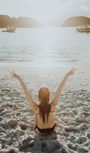 woman in black bikini bottom on beach during daytime