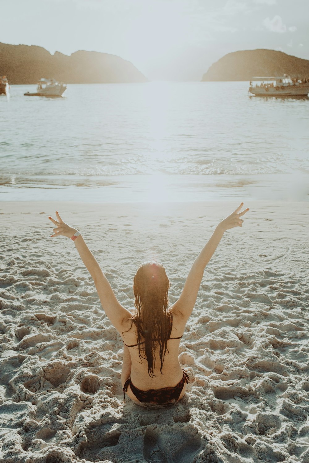 woman in black bikini bottom on beach during daytime