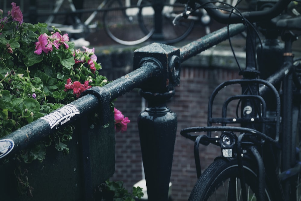 black bicycle with red flowers on top