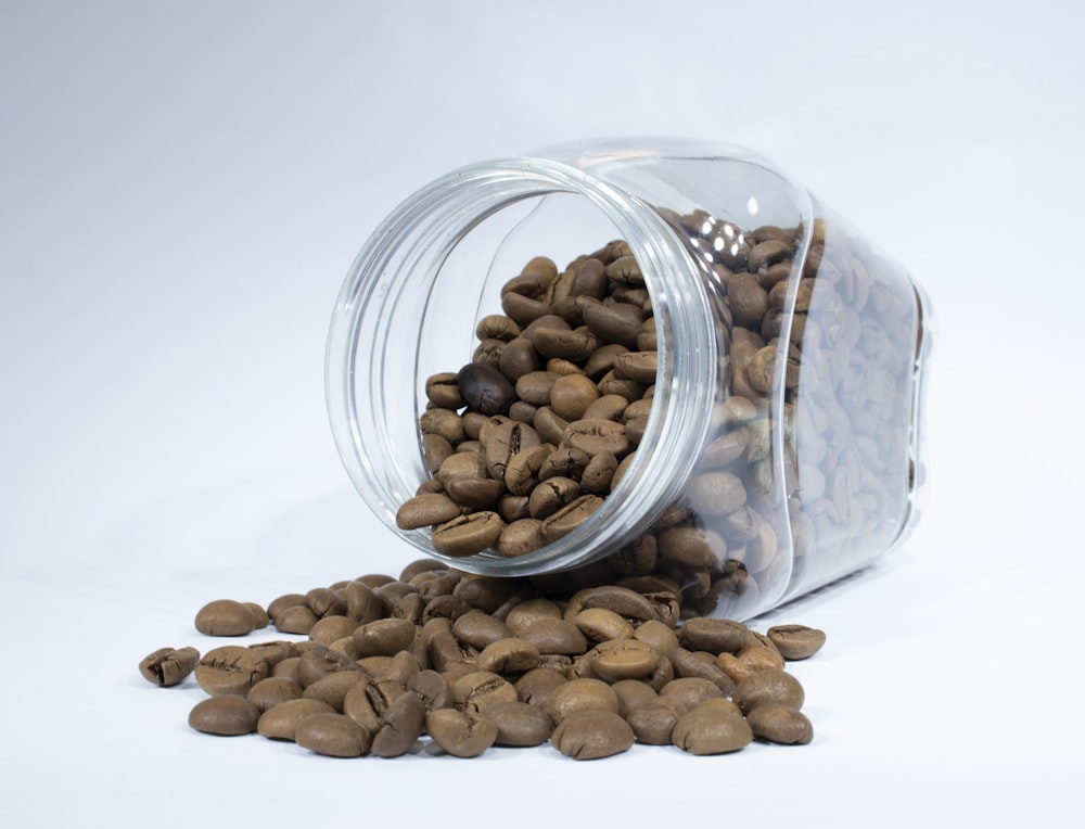 brown almond nuts in clear glass jar