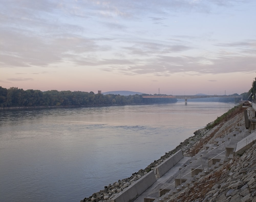 body of water near bridge during daytime