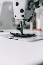 white sewing machine on white table