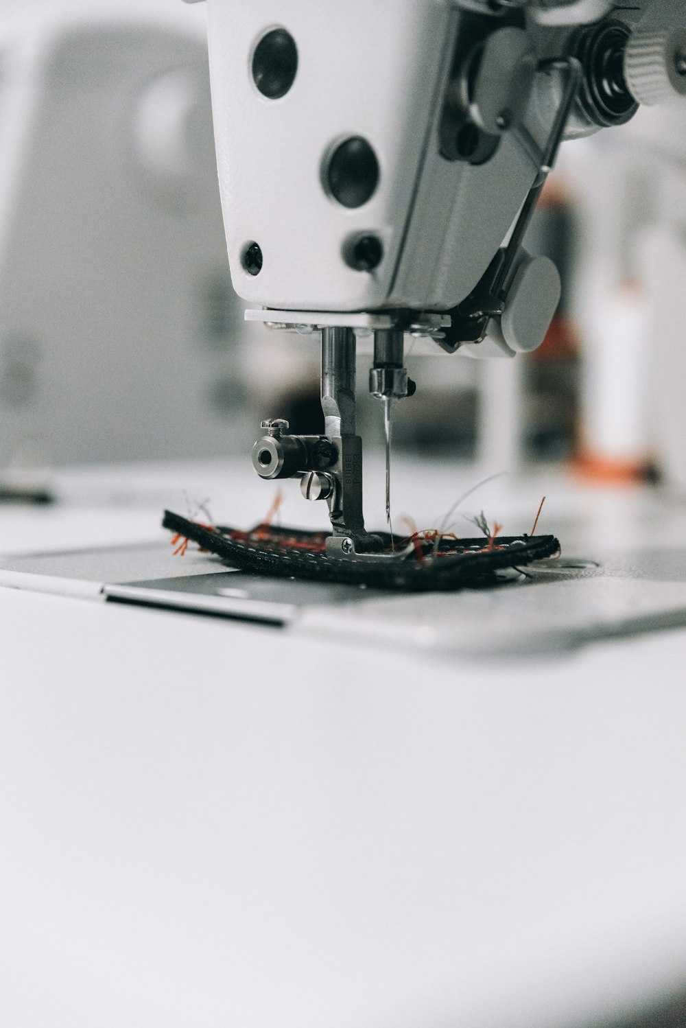 white sewing machine on white table