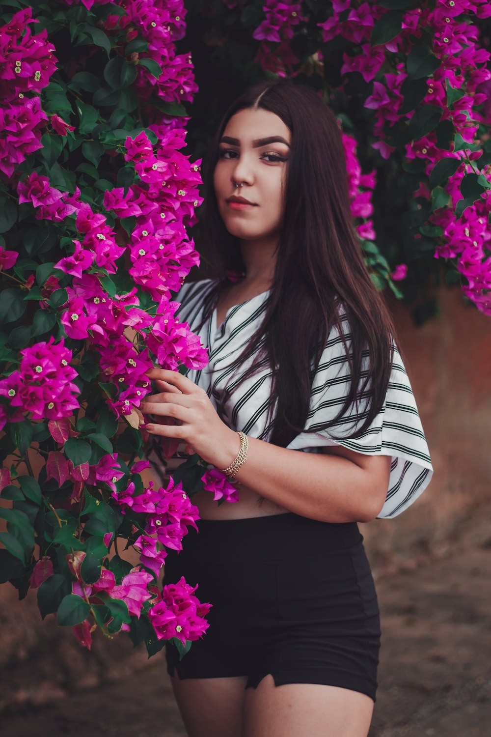 a woman in a striped shirt and black shorts