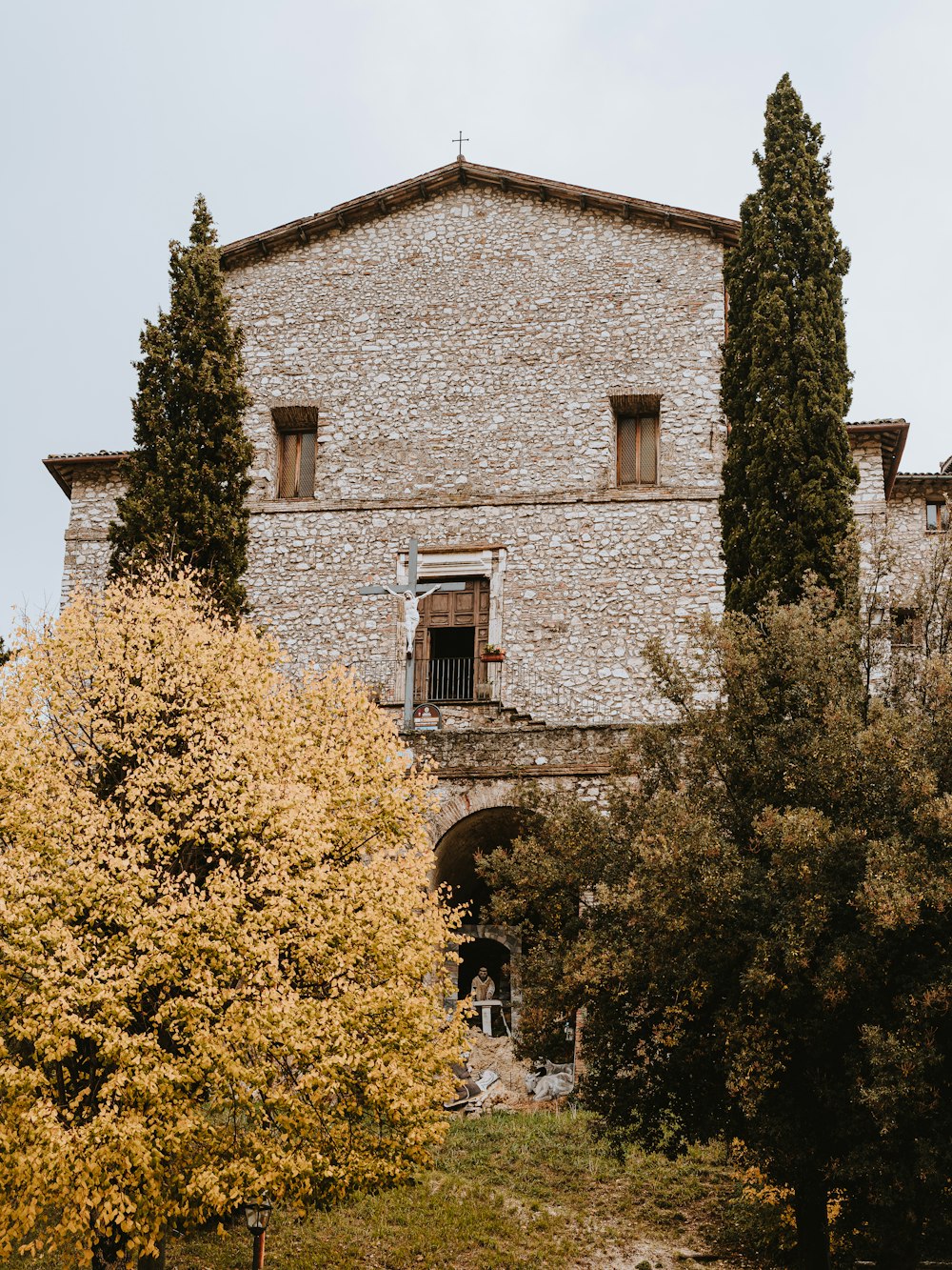 brown brick building near green trees during daytime