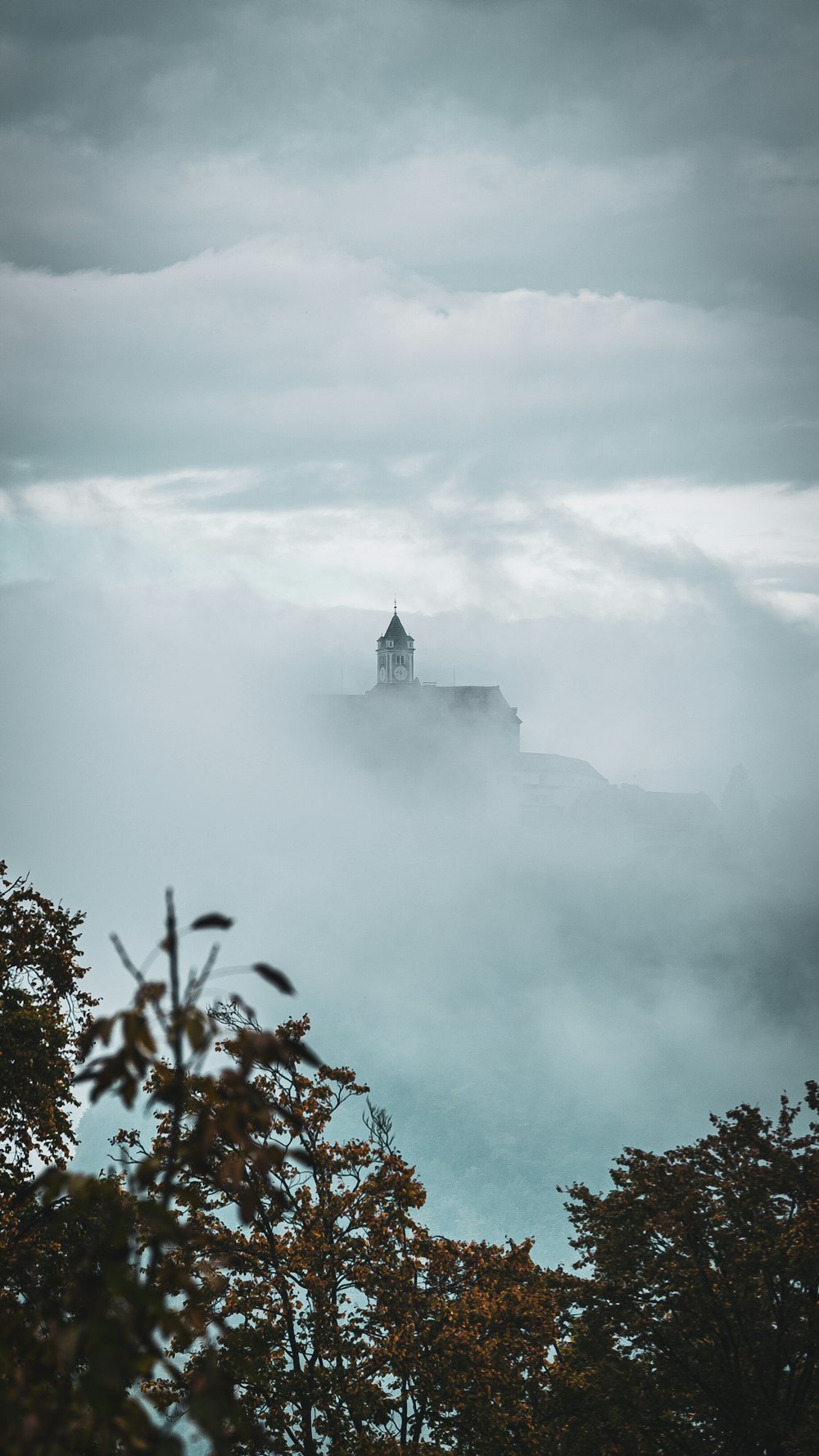 white and black castle on top of mountain