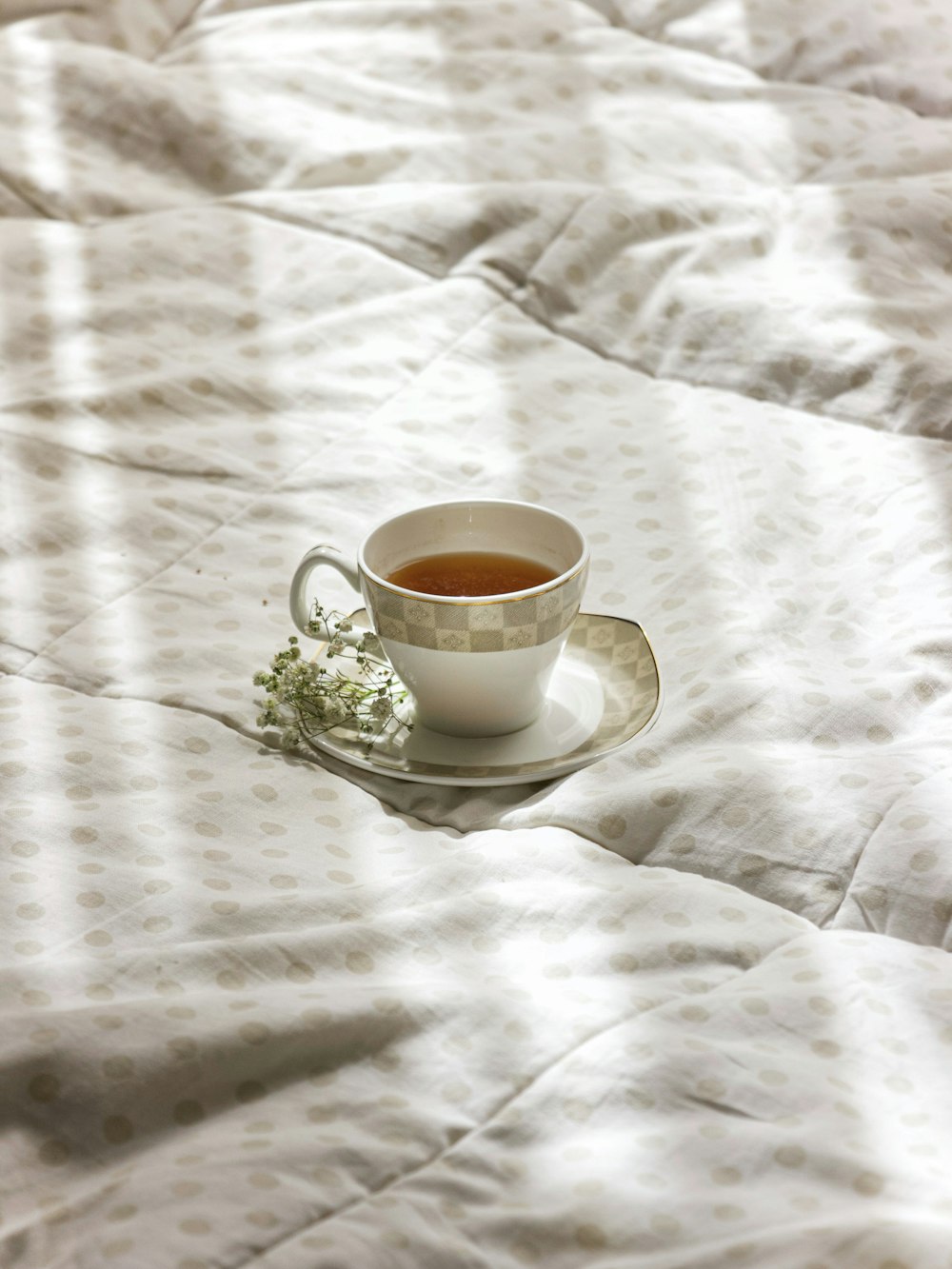 white ceramic cup on white saucer