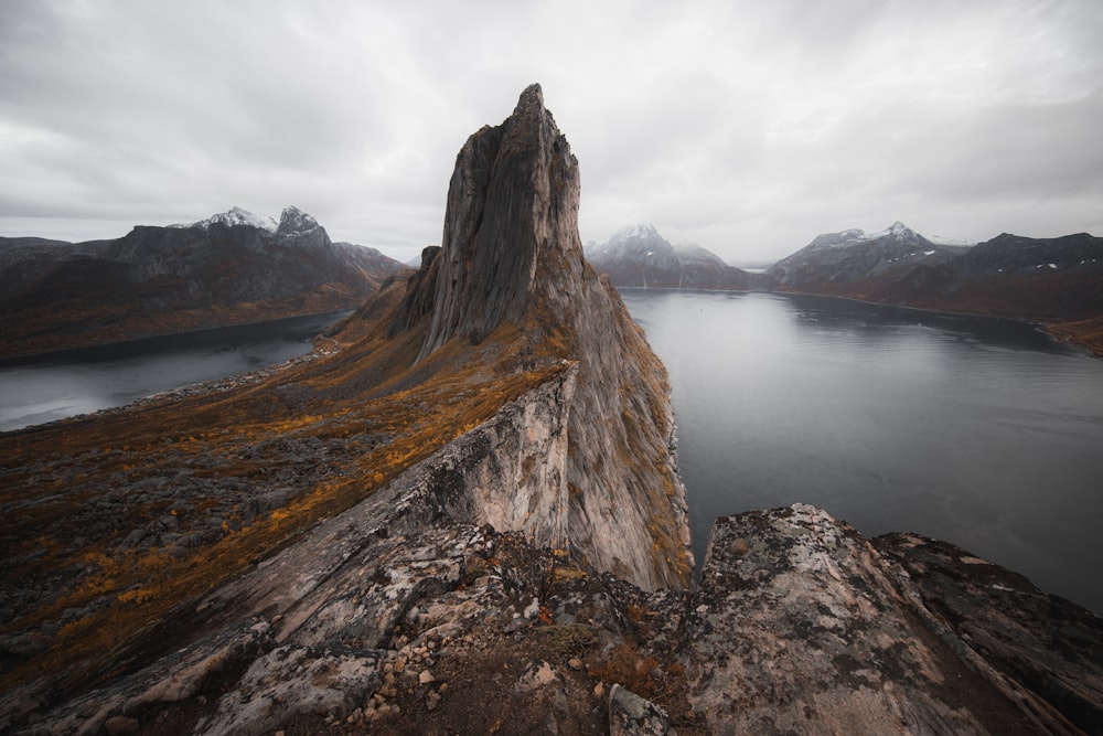 brown rock formation near body of water during daytime