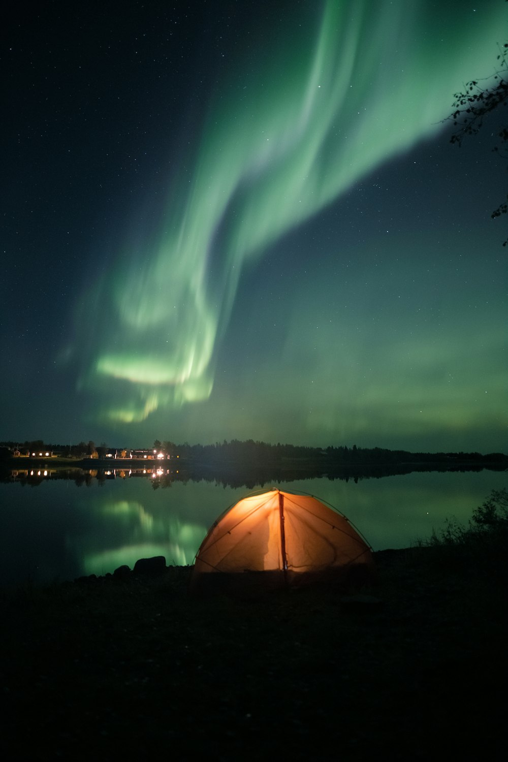 white tent near body of water during night time