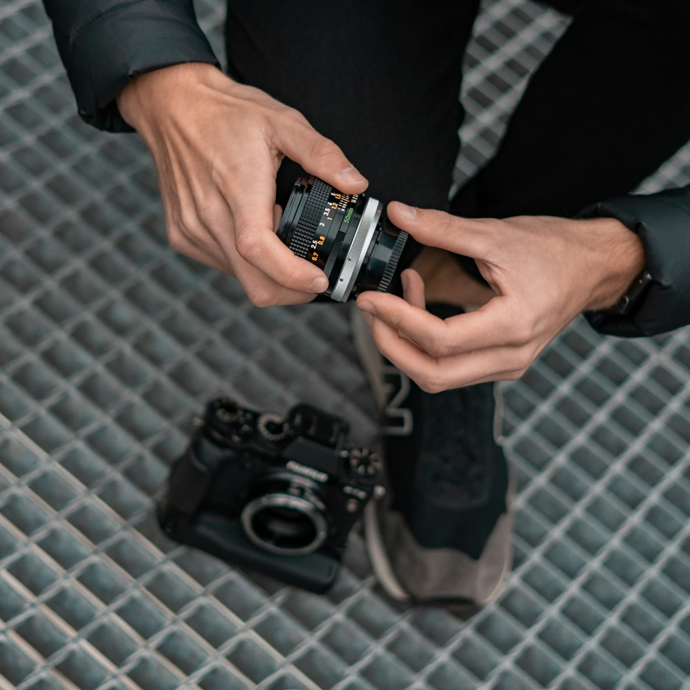 person holding black and silver dslr camera