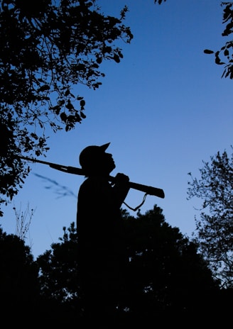 A hunter silhouetted against the morning sun, ready for the day ahead.