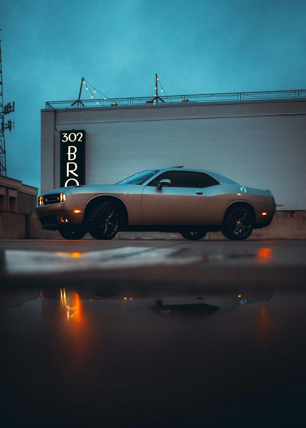 black porsche 911 parked near white and blue building during night time