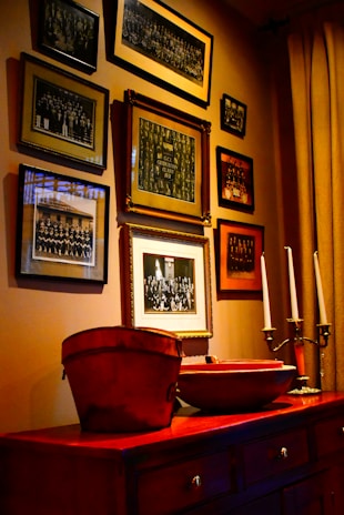 A beautifully arranged wall featuring elegant framed photos and artwork in a cozy living room.