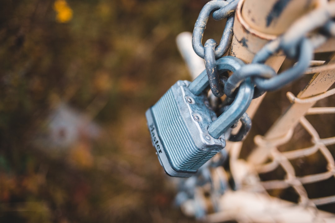 silver padlock on gray steel chain