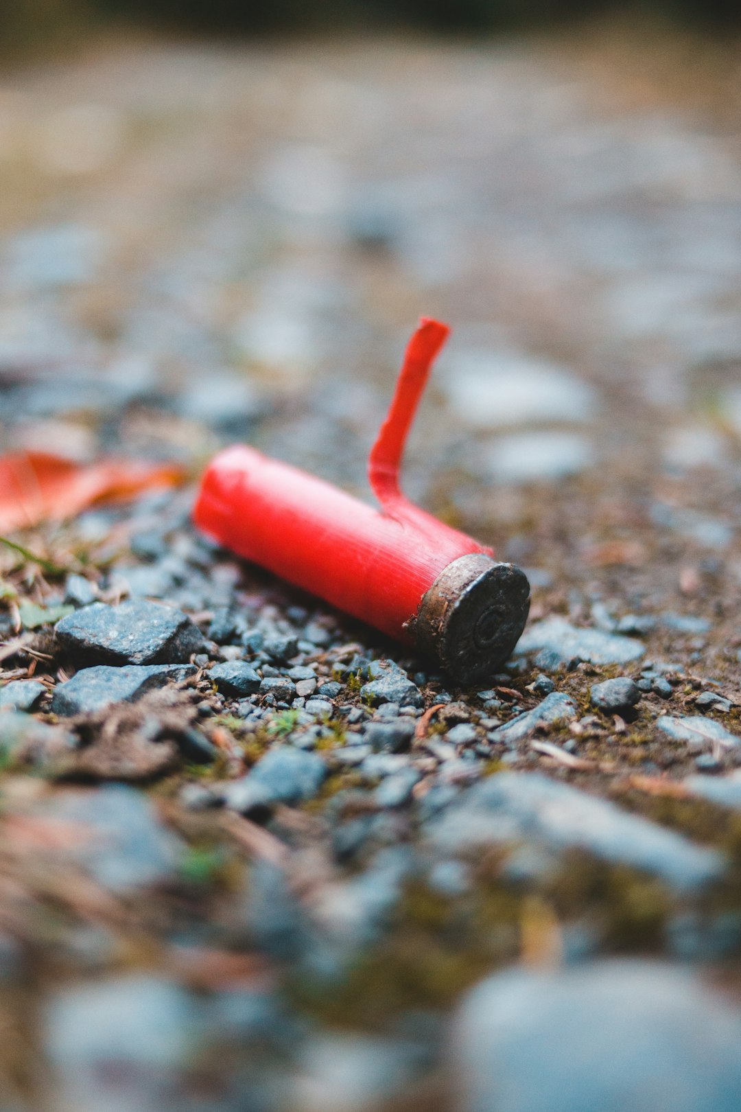 red and silver tube on ground