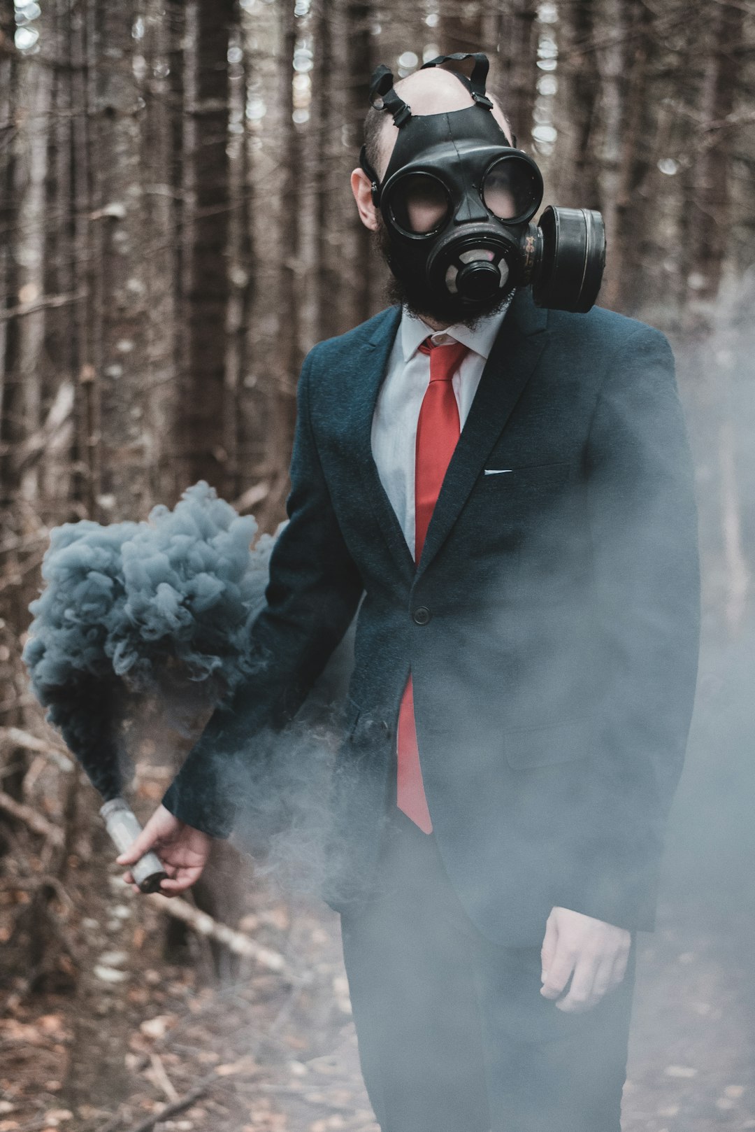 man in blue suit wearing gas mask