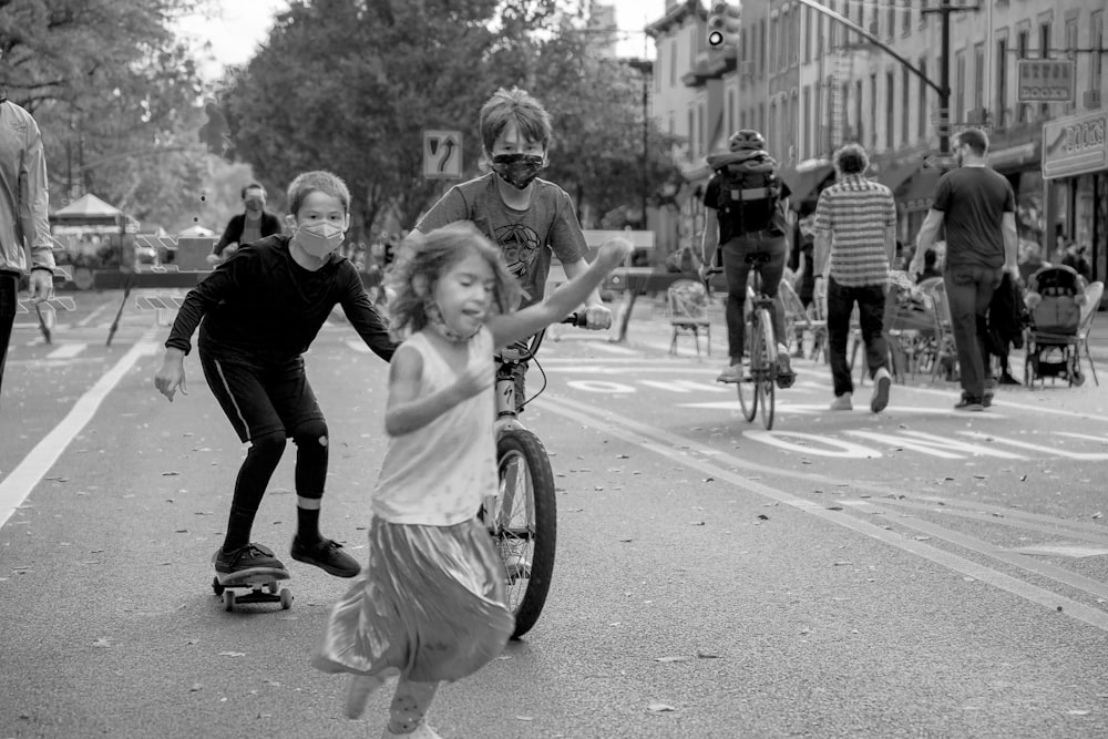 grayscale photo of woman and girl on bicycle