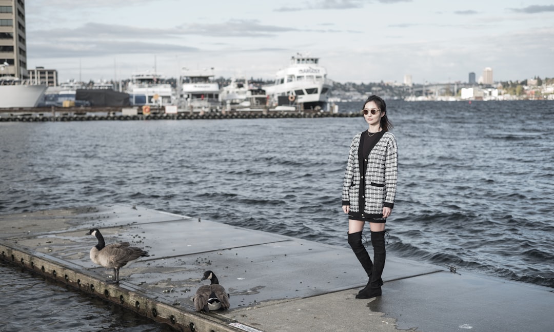 woman in black and white striped long sleeve shirt and black pants standing on dock during