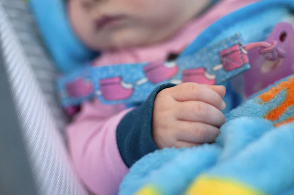 Young child secured in a convertible car seat