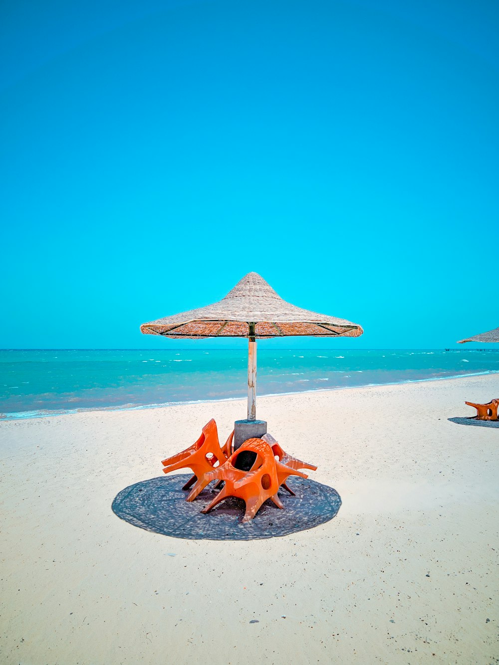 brown wooden beach umbrella on white sand beach during daytime