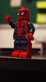 Vibrant superhero minifigure posed dynamically with a city backdrop.