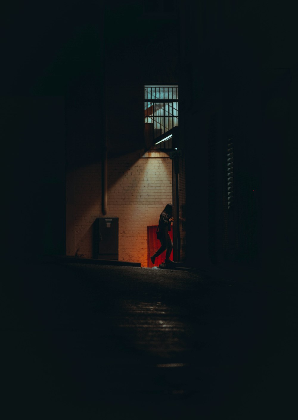 person in red dress walking on hallway