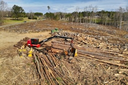 red and black heavy equipment on brown soil