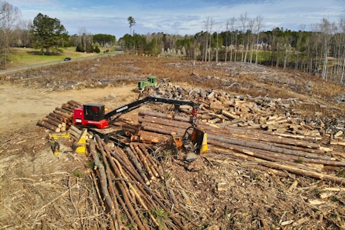 red and black heavy equipment on brown soil