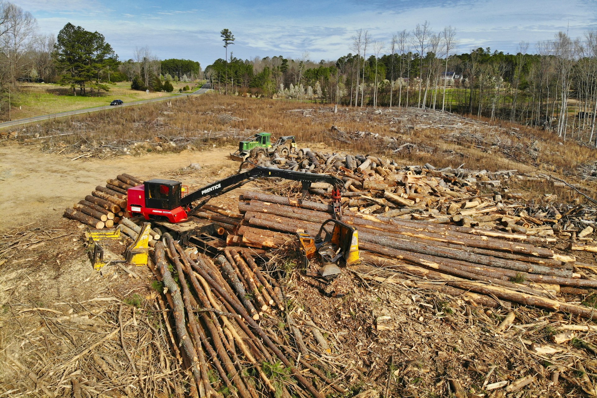 red and black heavy equipment on brown soil