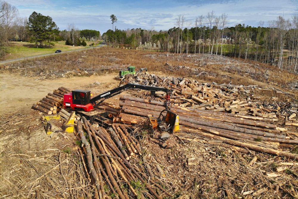 red and black heavy equipment on brown soil