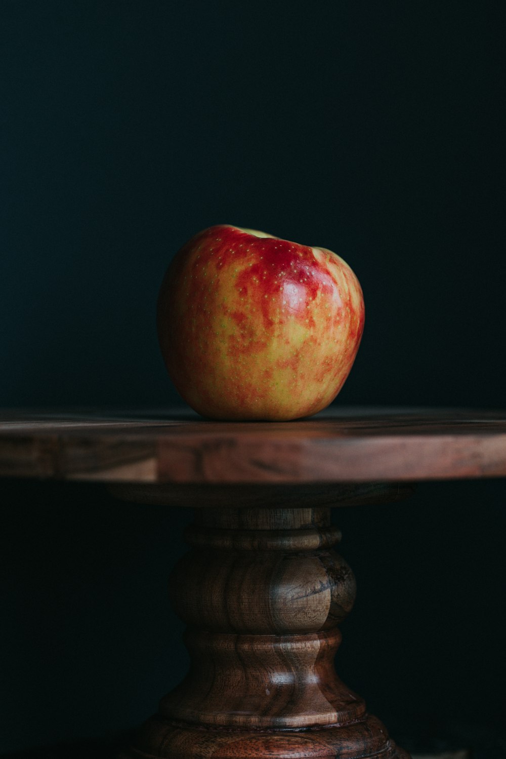 red apple fruit on brown wooden table