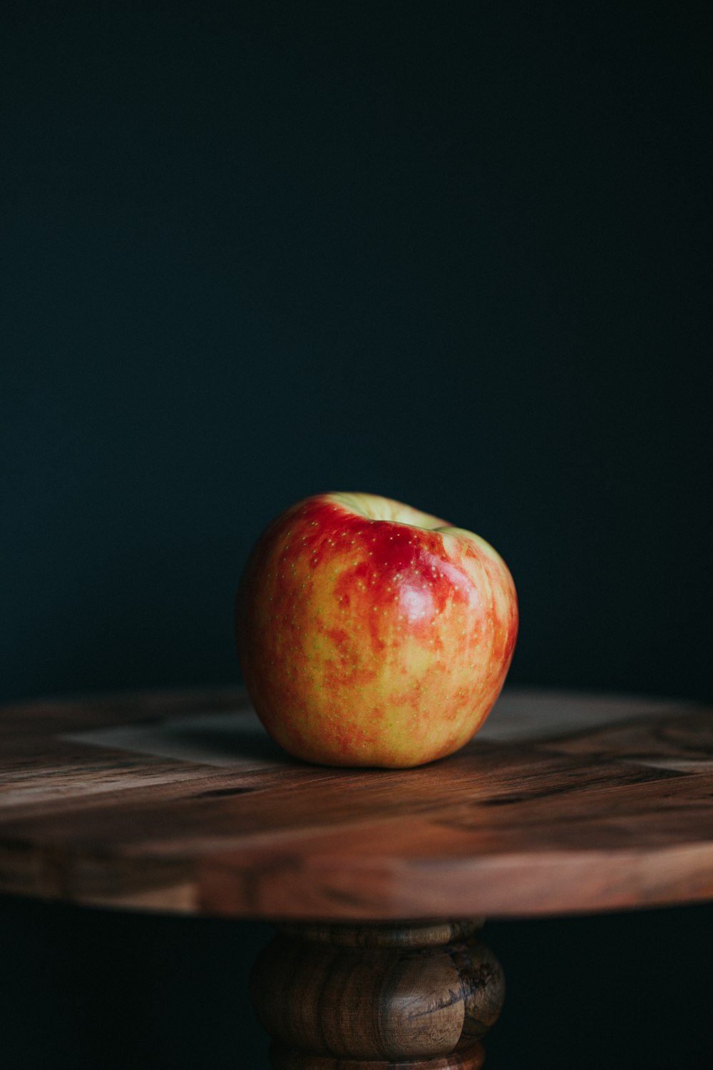 red apple on brown wooden table