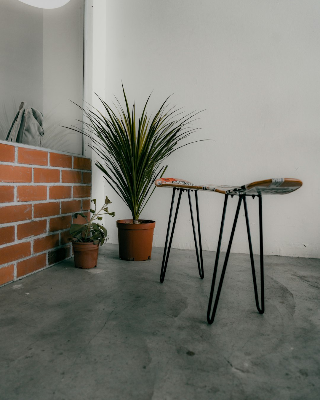 brown wooden table beside green plant